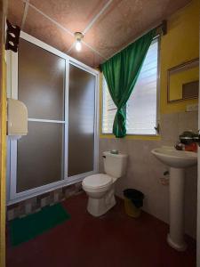 a bathroom with a toilet and a sink at Casa Maya Itza in Flores +171 photos