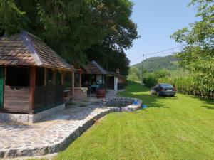 a house with a car parked in a yard at Vila Krasava in Krupanj