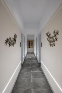 a hallway with white walls and a tile floor at Dilion Hotel in Parikia