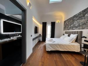 a bedroom with a bed and a sink and a mirror at Gioiamia - Luxury Rooms in Cattedrale in Palermo