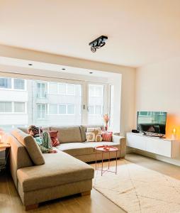 a woman laying on a couch in a living room at BLOSS. in Ostend +16 photos