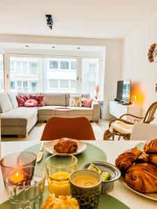 a living room with a table with food on it at BLOSS. in Ostend