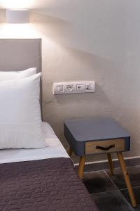 a bedroom with a bed and a nightstand next to a bed at Dilion Hotel in Parikia