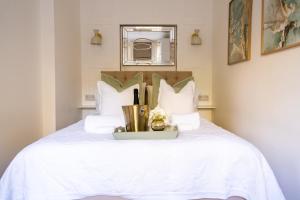 a bedroom with a white bed with white pillows at No 2 at Albion Terrace in Bath