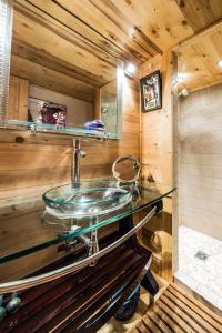 a bathroom with a glass sink in a cabin at Les Mules in Combloux