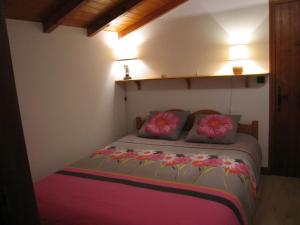 a bedroom with a bed with flowers on it at Les Mules in Combloux