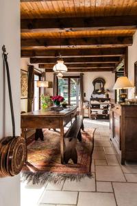 a kitchen with a wooden table and a dining room at Les Mules in Combloux