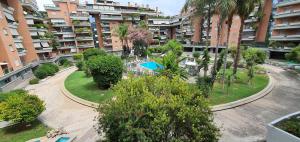 an apartment complex with a courtyard with a pool and trees at Home-like Apartment in Rome