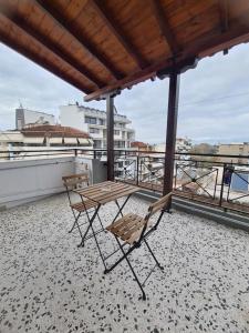 a couple of chairs and a table on a roof at Apartment in the heart of the city 5Β in Larisa