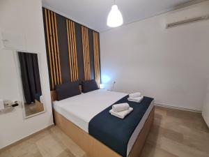 a bedroom with a bed with two towels on it at Apartment in the heart of the city 5Β in Larisa