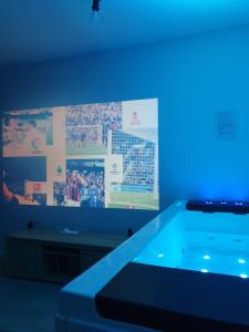 a room with a tv and a swimming pool at SPA Détente jacuzzi cinéma farniente in Dugny