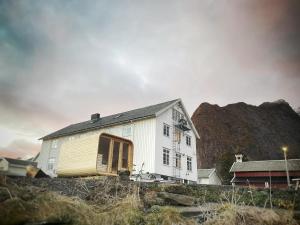 a house that is sitting on top of a hill at Catogården - Boutique Home & Activity Centre in Reine