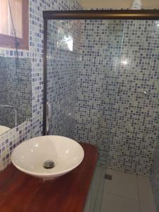 a bathroom with a sink and a glass shower at Pousada Casa Na Bolom in Barra Grande +23 photos