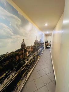 a hallway with a wall mural of a city at Appartamento Mellini in Rome