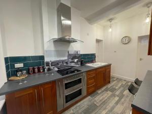 a kitchen with a sink and a stove top oven at The Old Station, Station House, Snettisham Norfolk in Snettisham