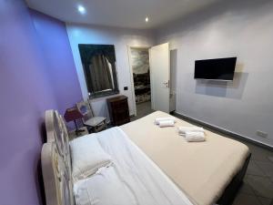 a bedroom with two beds and a flat screen tv at Appartamento Mellini in Rome