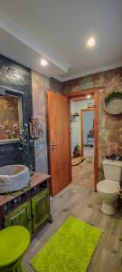 a bathroom with a sink and a toilet in a room at Casa Odélia in Almargem do Bispo +56 photos