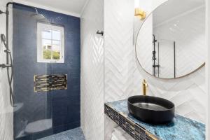 a bathroom with a black sink and a mirror at Beautiful Oistins Home Away From Home in Christ Church