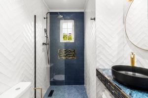 a bathroom with a black sink and a shower at Beautiful Oistins Home Away From Home in Christ Church