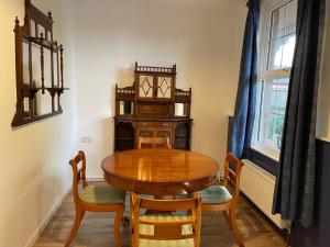 a dining room with a wooden table and chairs at The Old Station, Station House, Snettisham Norfolk in Snettisham