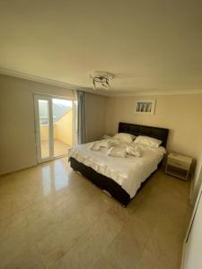 a bedroom with a bed and a large window at Excellent 3 storey villa with a swimming pool in Belek