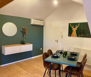 a dining room with a blue table and chairs at Platzhirsch in Kehl am Rhein