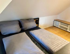 a room with two beds and a table in it at Platzhirsch in Kehl am Rhein