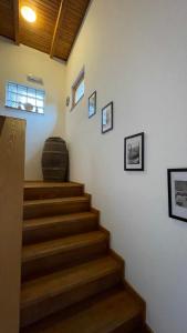 a staircase in a house with a barrel on the wall at Guest House Alpha Ski Camp in Jahorina