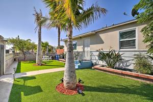 a yard with two palm trees and a house at Contemporary 2 BR House w/ Yard, near Balboa & Downtown in National City