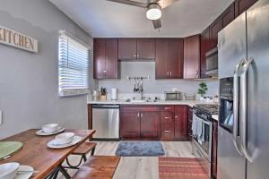 a kitchen with wooden cabinets and a table and a refrigerator at Contemporary 2 BR House w/ Yard, near Balboa & Downtown in National City