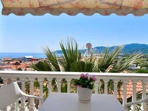 a table on a balcony with a view of the ocean at Haus Despina in Sarti