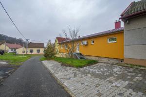 a yellow house with a cobblestone street at Velký apartmán Zlámanka in Kroměříž