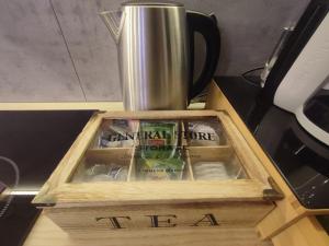 a wooden box with a coffee pot on top of a stove at Cocon Lux au centre de Voiron in Voiron