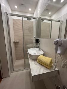 a bathroom with a shower and a sink and a shower at Guest House Alpha Ski Camp in Jahorina