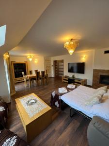 a living room with two beds and a table at Apartament Pieniny Dream in Krościenko