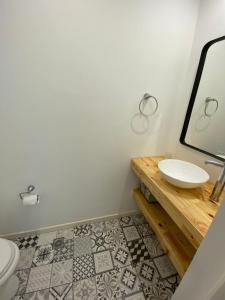 a bathroom with a sink and a mirror at ROMA apartamento frente al mar in Mar del Plata