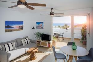 a living room with a couch and a table at Atico En Las Negras in Las Negras