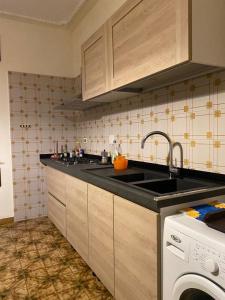 a kitchen with a sink and a washing machine at Casa Andrea in Ghedi