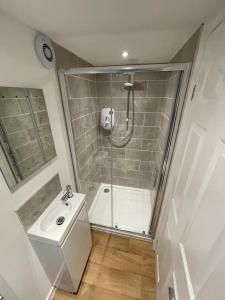 a bathroom with a shower and a sink at *Close to Beach* One Bedroom Suite with Parking in Overstrand