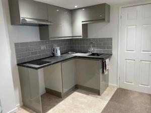 a kitchen with a sink and a counter top at *Close to Beach* One Bedroom Suite with Parking in Overstrand