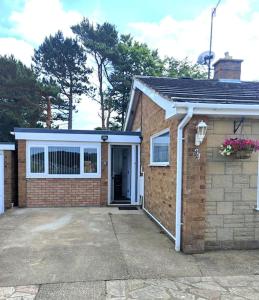 a brick house with a door and a garage at *Close to Beach* One Bedroom Suite with Parking in Overstrand