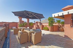 
a large open umbrella sitting on top of a brick building at Riad Le Perroquet Bleu Suites & Spa in Marrakech
