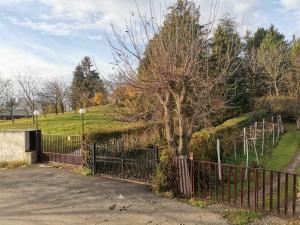 a fence with a tree in front of a field at Extra Fruske in Vrdnik