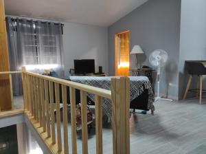 a living room with a bed and a balcony at Casa da Guida in Angra do Heroísmo