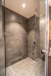 a shower with a glass door in a bathroom at Serre Chevalier Monêtier les Bains T3 jardin Appartement les Mélèzes in Le Monêtier-les-Bains +33 photos