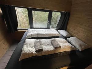 two beds in a room with a window at Chalet FiMiLi in Vyšná Boca