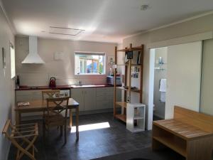 a kitchen with a table and a dining room at Totara Cottage in Twizel