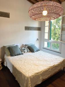 a bedroom with a bed and a chandelier at Under the Tower in Pisa