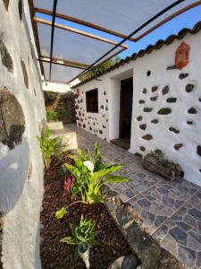 a patio of a house with a stone wall at CASA TIO MANUEL in La Tierra del Trigo