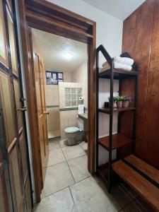 a bathroom with a toilet and a sink and a door at Casa Lomas Grangelo in Atlixco +56 photos